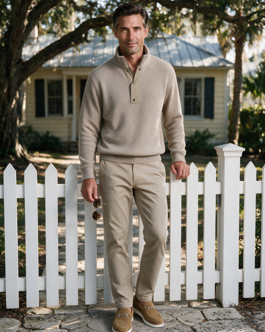 Oatmeal ribbed knit quarter-zip with khaki five-pocket trousers and suede bit loafers at an Old Naples cottage gate
